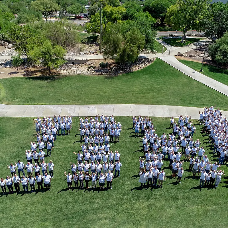 Ground of people in white spelling out IBM