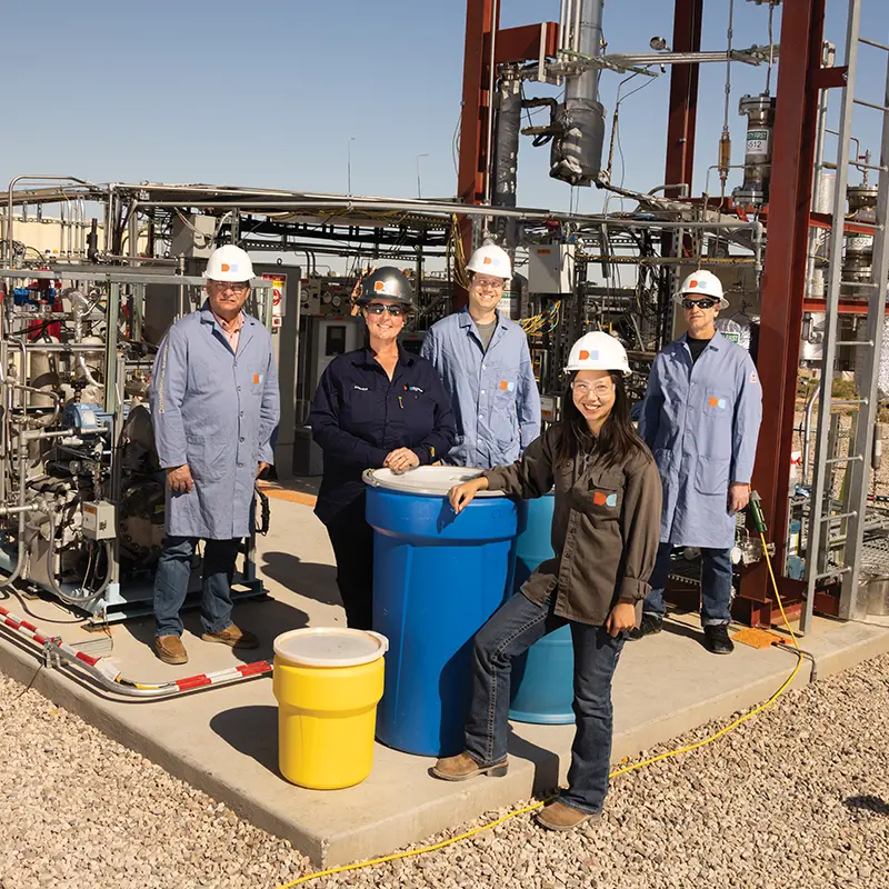 5 scientists standing in front of energy equipment