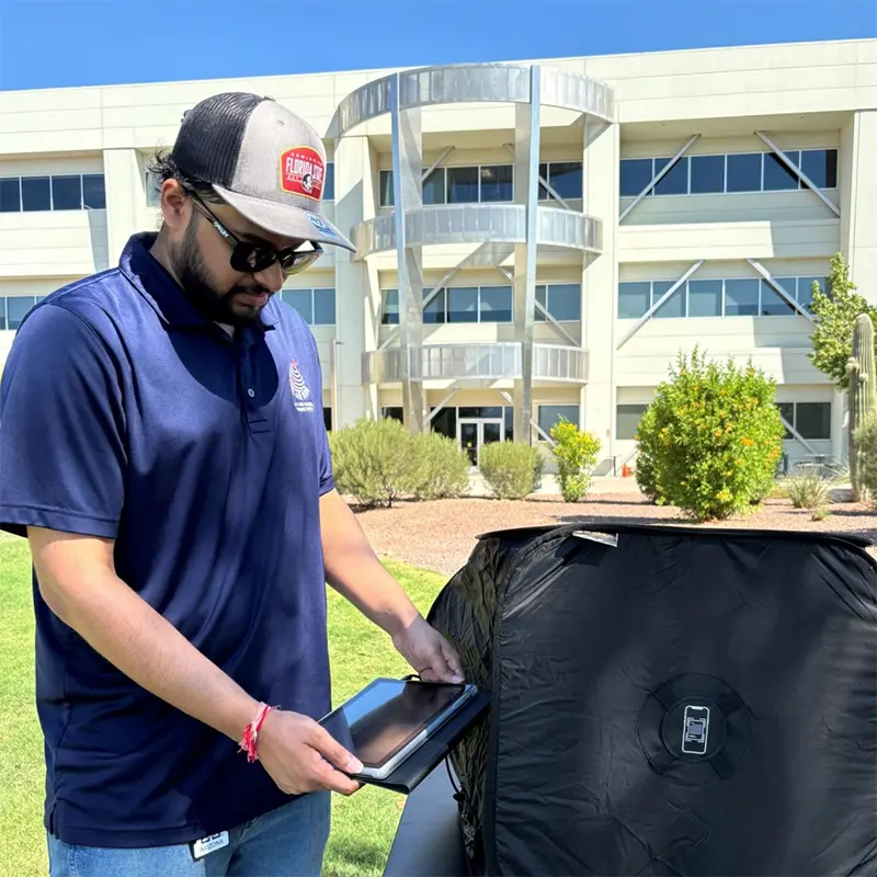 Man holding iPad near computer shield