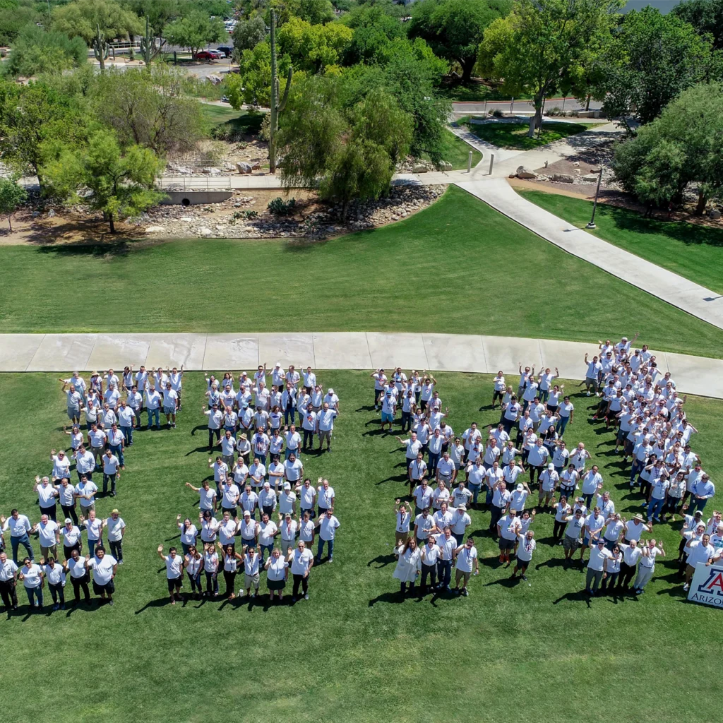 Ground of people in white spelling out IBM