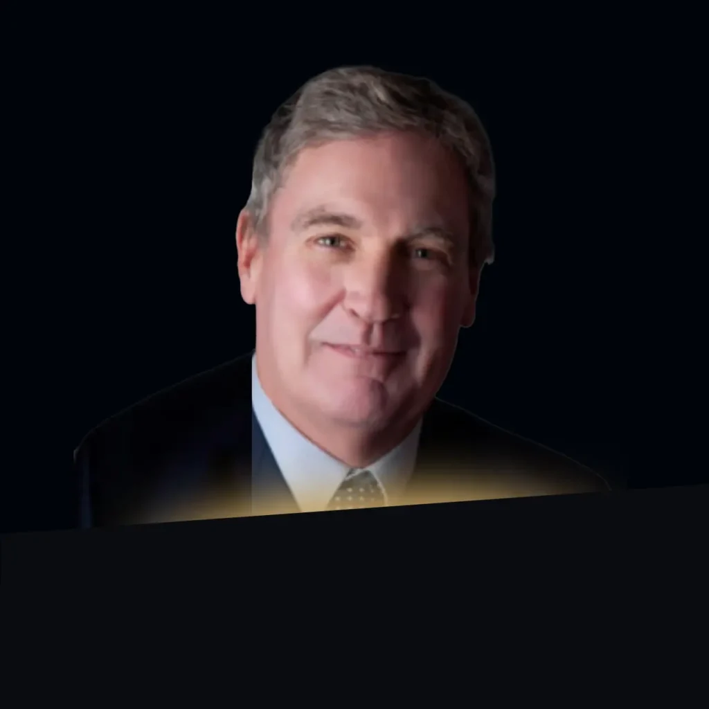 Patrick Griffin headshot wearing dark blue blazer with gold glow at the bottom of photo