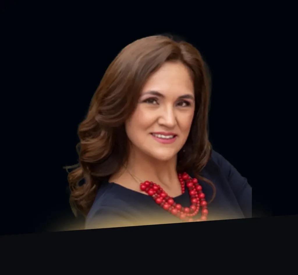 Karla Bernal Morales headshot wearing navy top with red necklace with gold glow at the bottom of photo