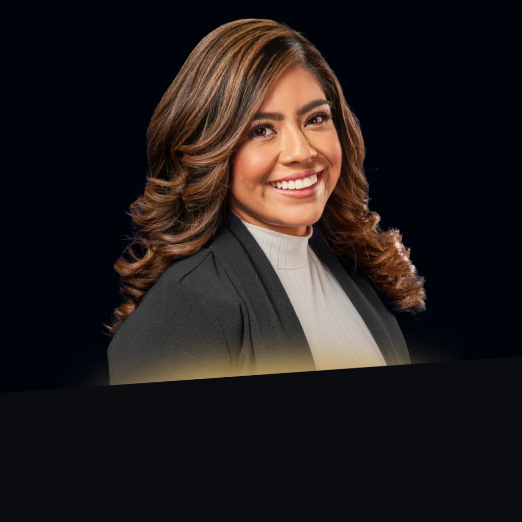 Headshot of Jackie Nunez wearing a black blazer with gold glow at the bottom