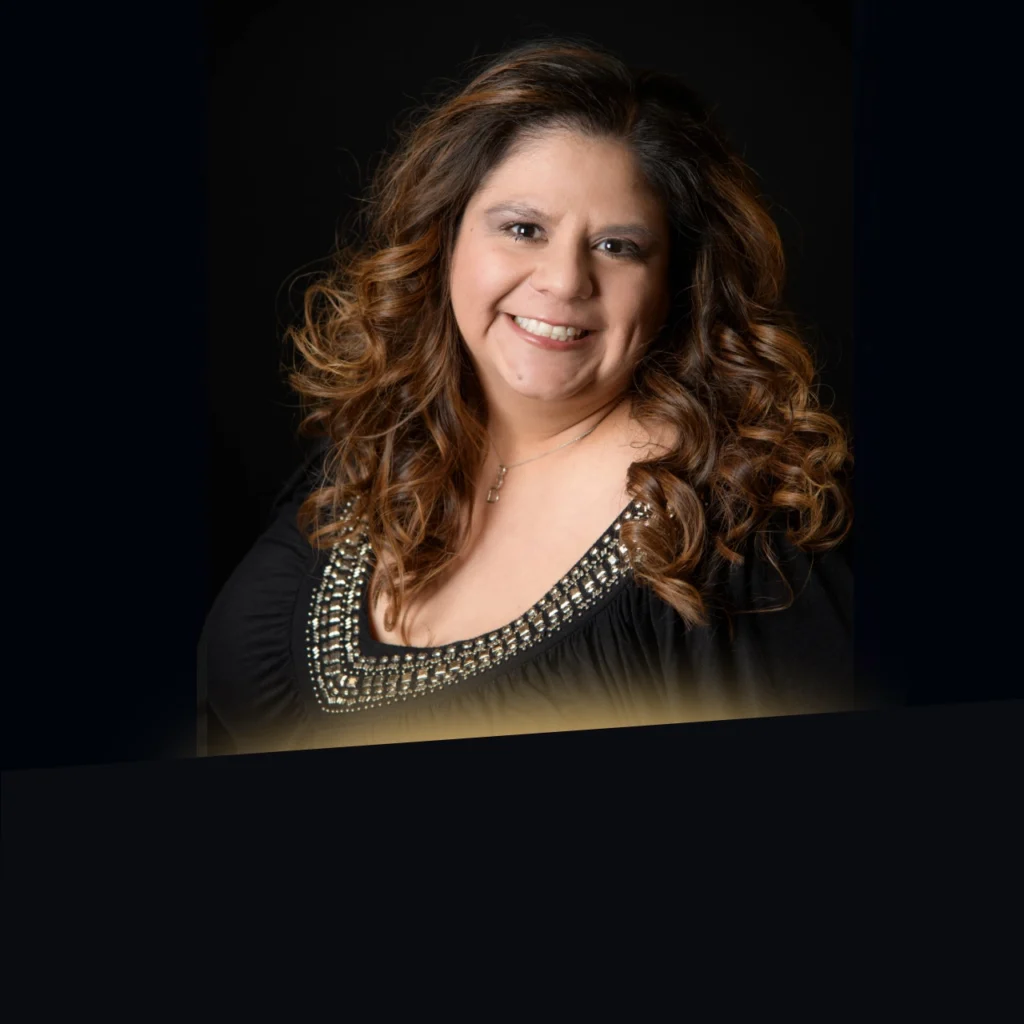 Headshot of Bernadette Franco wearing a black shirt with gold glow at the bottom