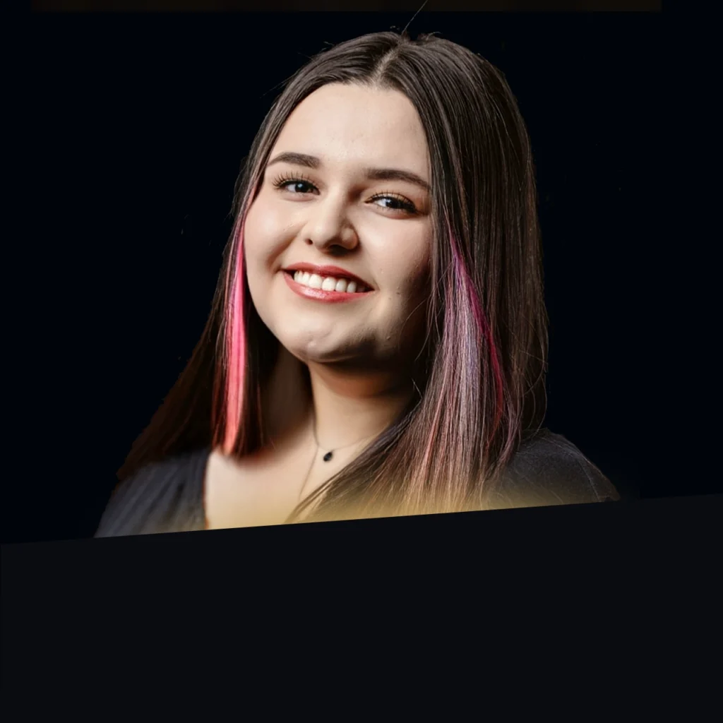 Headshot of Aliana Campas wearing a black blazer with gold glow at the bottom