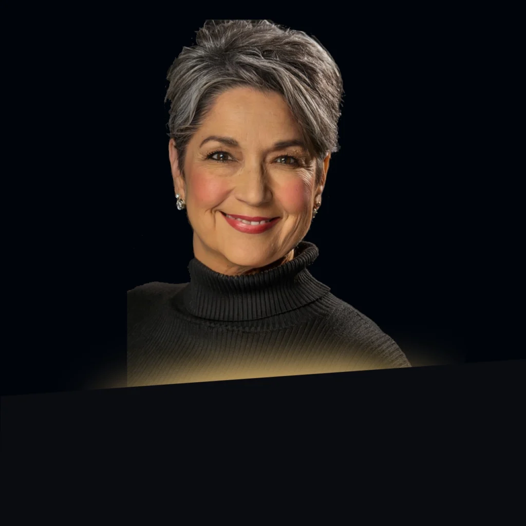 Headshot of Izelda Mendez wearing a black turtleneck with gold glow at the bottom