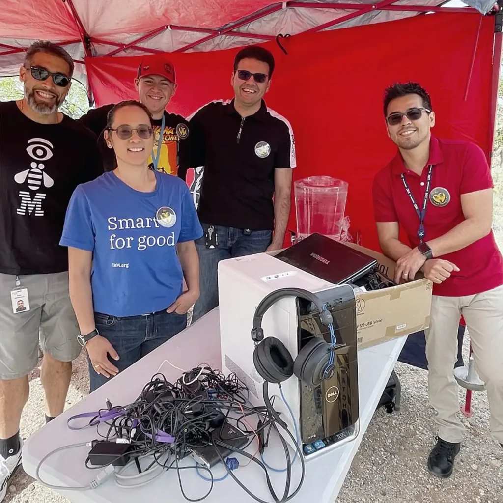 5 men posing for photo around donated tech