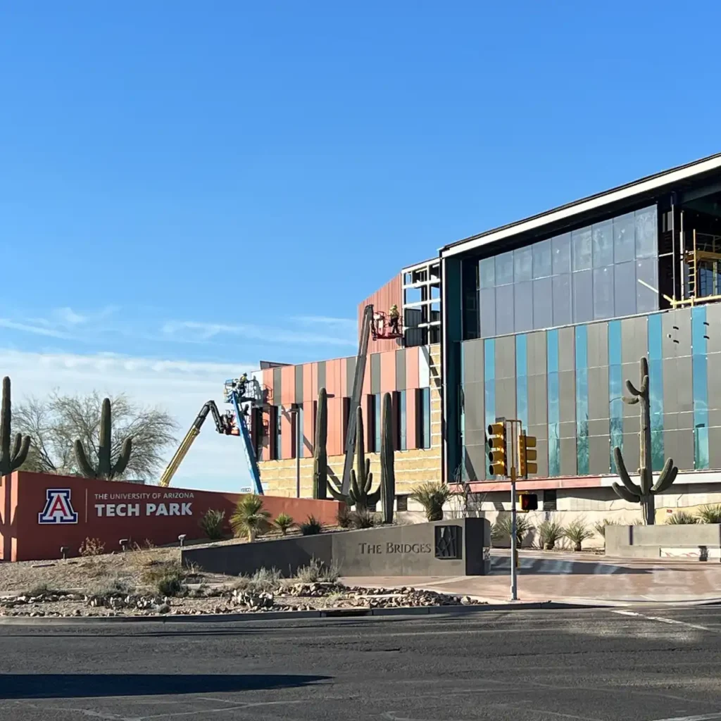 Construction on building behind UA Tech Park at The Bridges monument sign