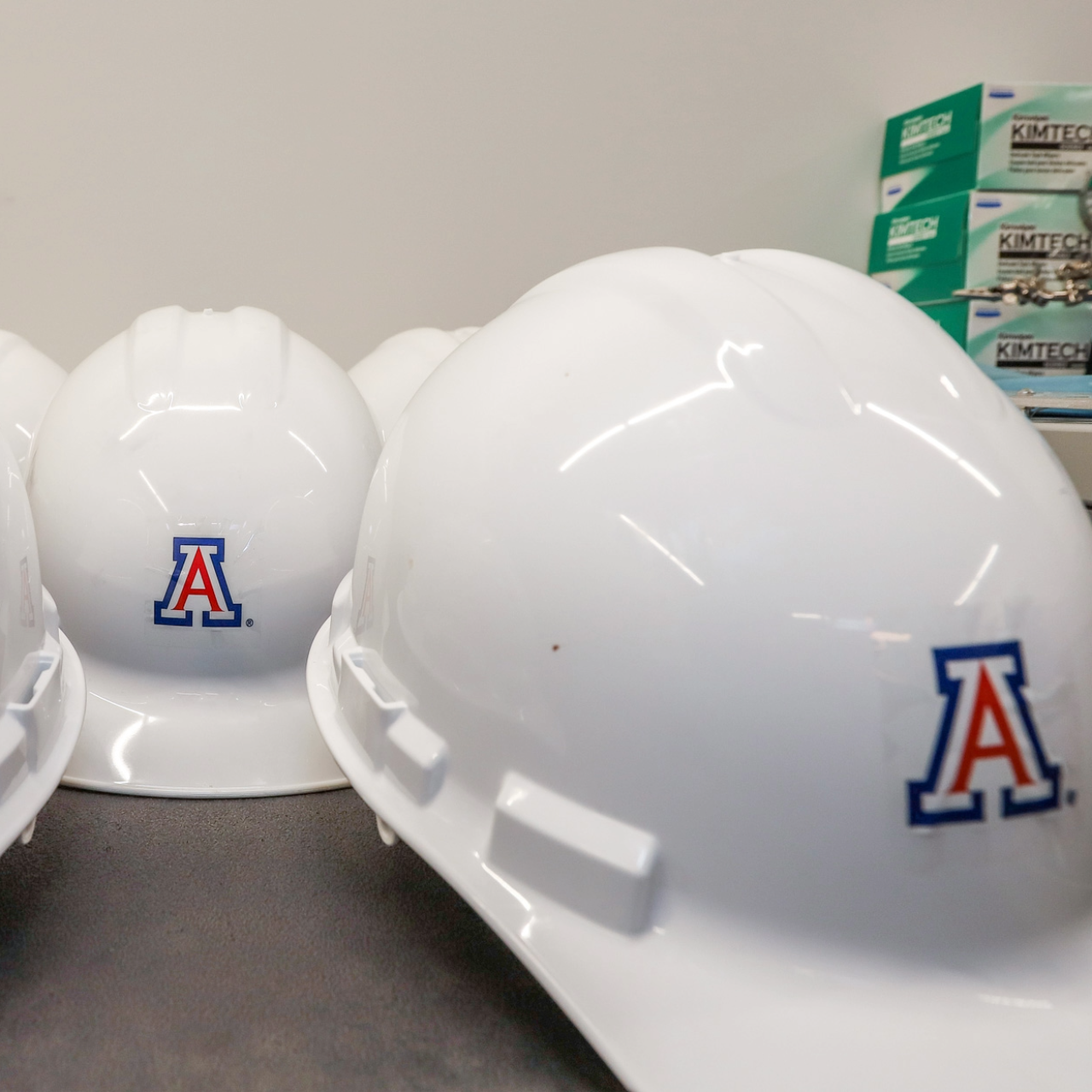 White construction hats with block a logo.
