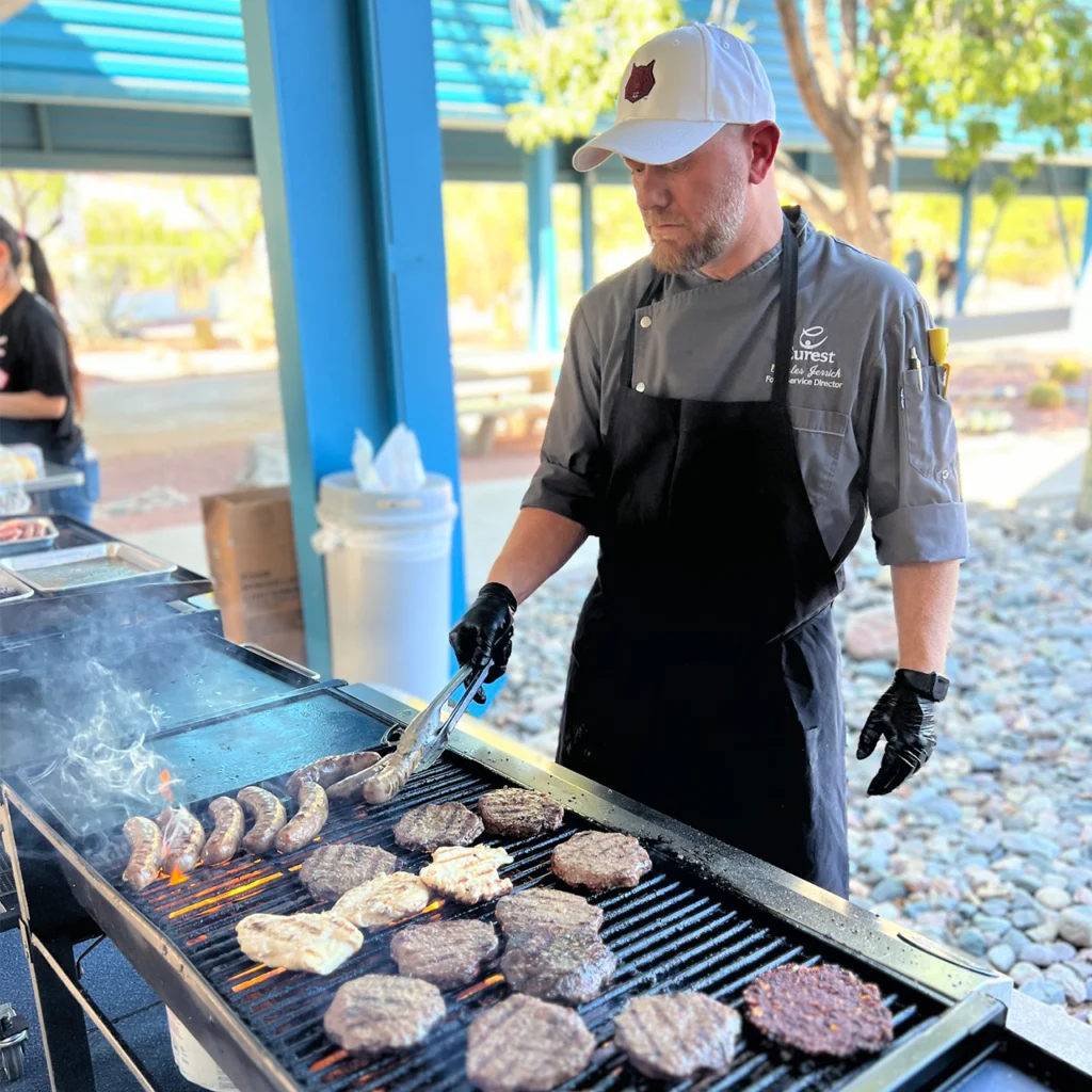 Chef cooking burgers on a grill