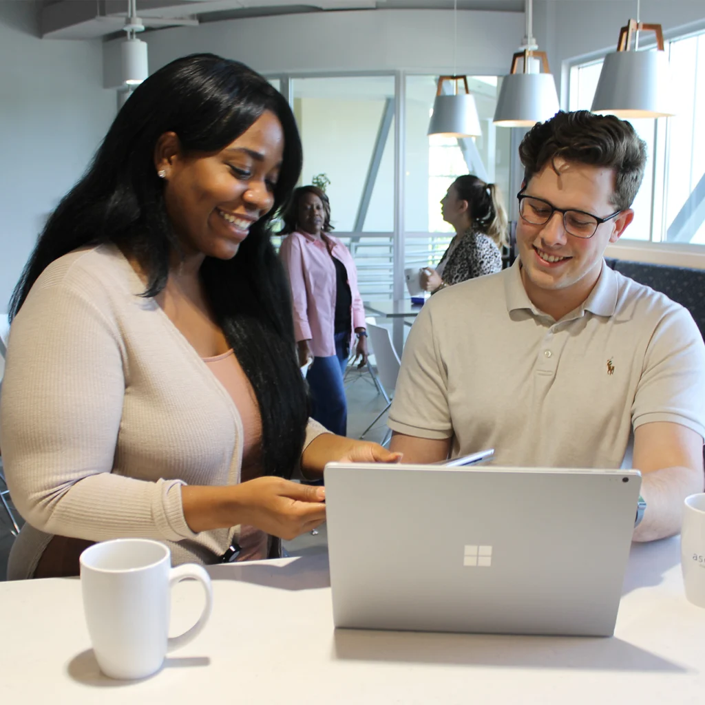 Two professionals looking at a computer