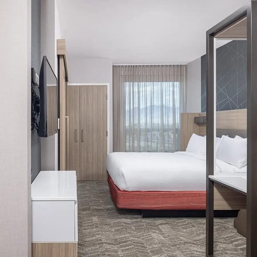Hotel room with bed with white sheets.