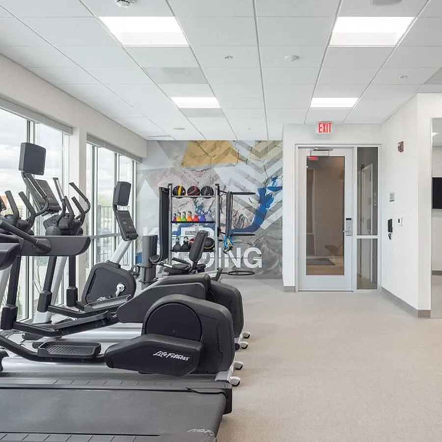 Gym with equipment near a window.