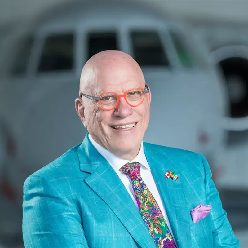 Headshot of Glenn Williamson wearing a teal suit and colorful tie.