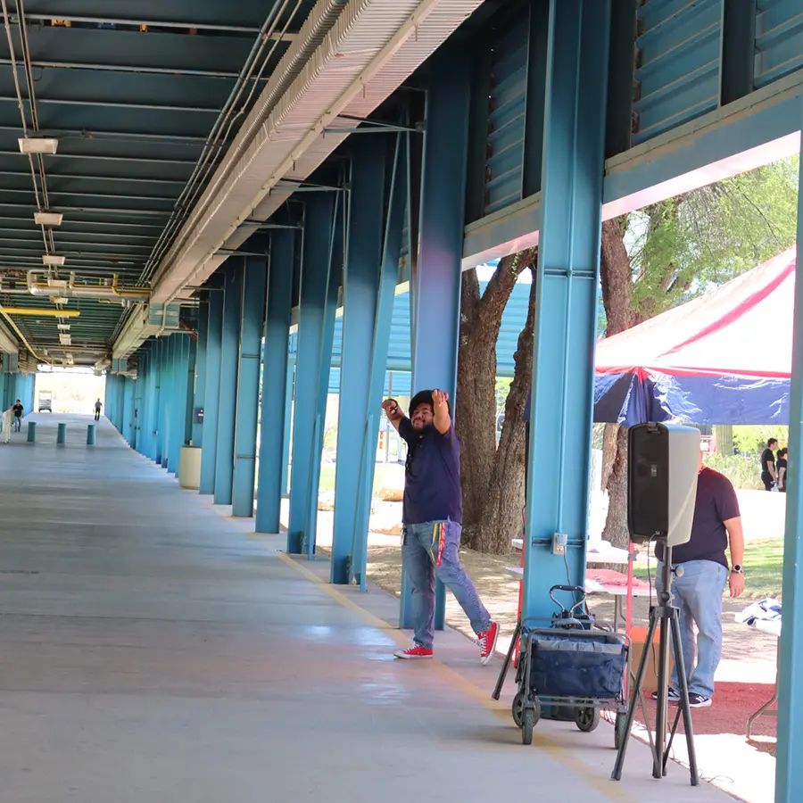 Man posing for photo under blue walkway